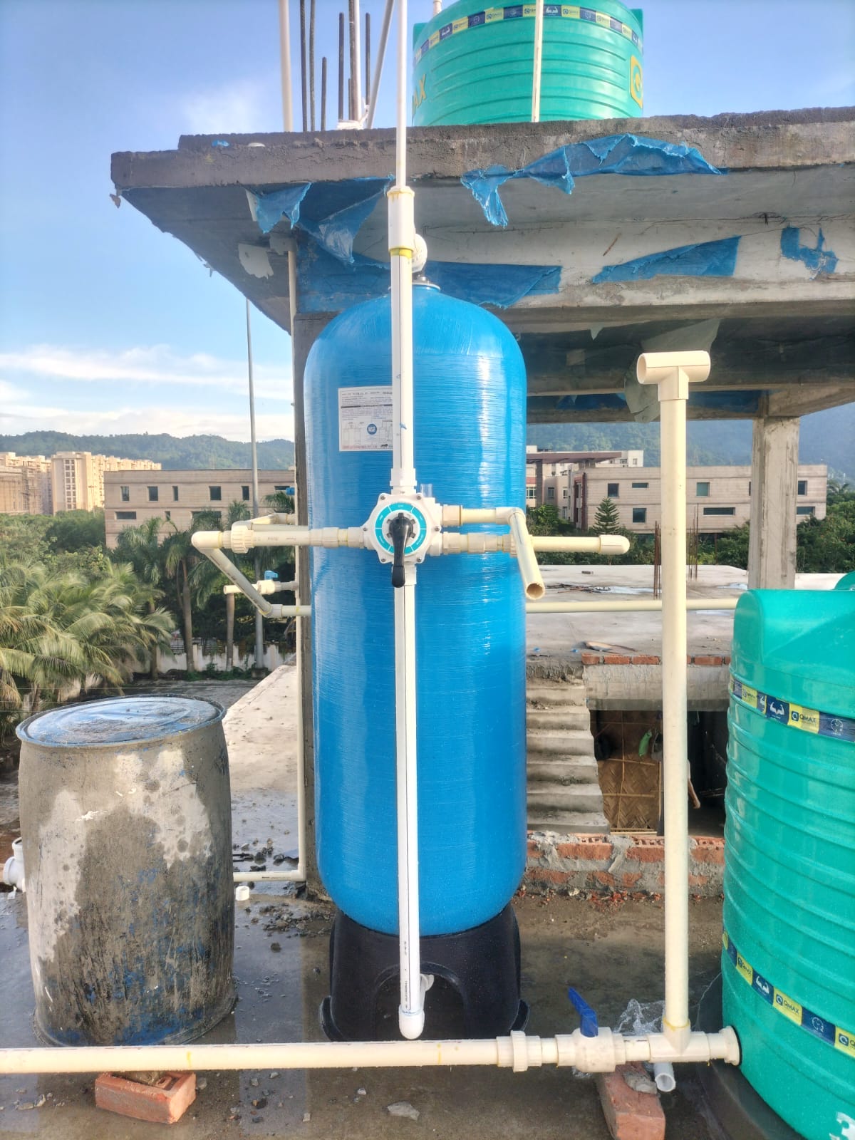 Rooftop FRP iron removal filter connected to overhead water tanks