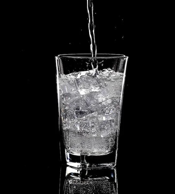 Crystal-clear water being poured into a glass of ice